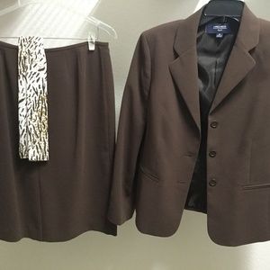 Woman’s brown suit with scarf.